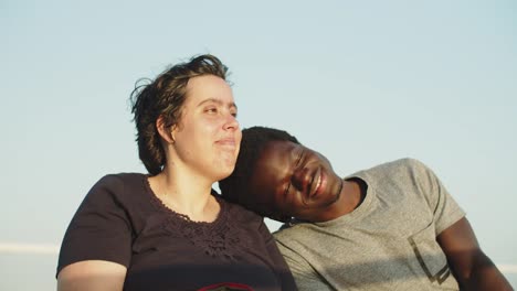 portrait of happy couple using wheelchairs sitting together