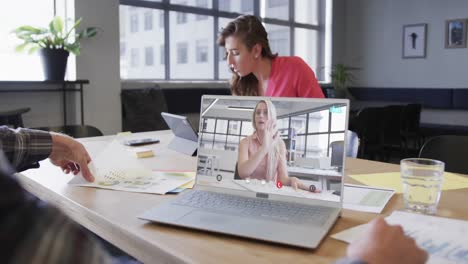 Caucasian-businessman-on-laptop-video-call-with-caucasian-female-colleague-on-screen