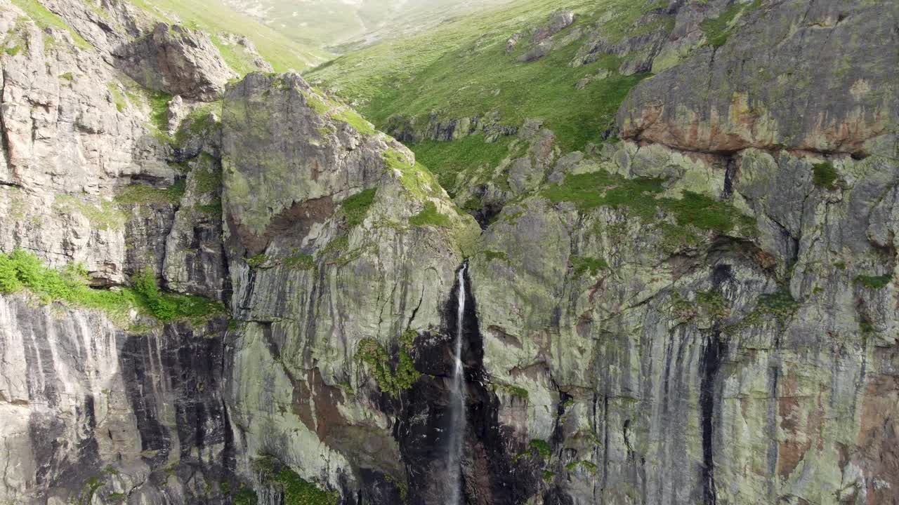 Rayskoto Praskalo Waterfall Pouring Through Towering Cliffs in the Balkan Mountains, Bulgaria, aerial pan