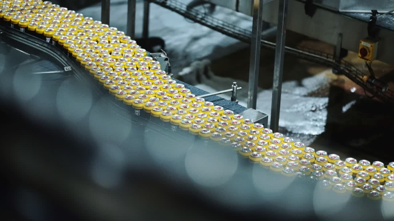 Soda cans moving through a factory