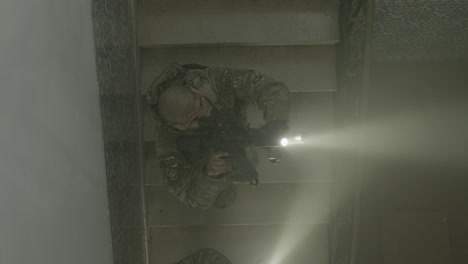 soldier with rifle and flashlight climbing ladder slowly