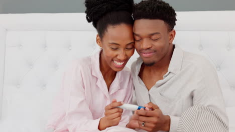 Couple,-kiss-and-smile-after-pregnancy-test-result