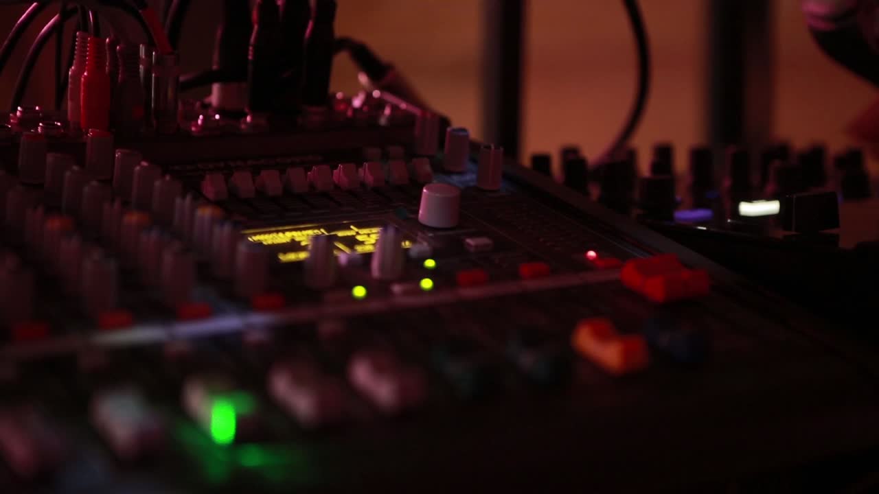 Hand Of The Sound Producer. Fingers move the sliders on the sound mixer