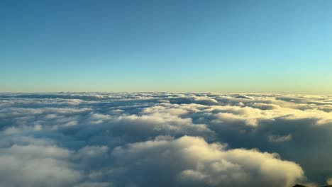 Clouds-overflight-day-light-with-blue-sky-from-a-plane-cockpit