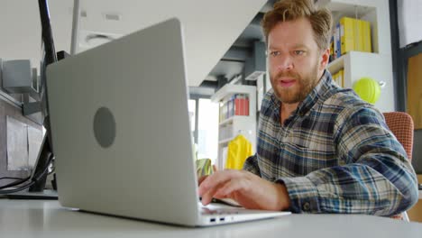 male architect using laptop at desk 4k