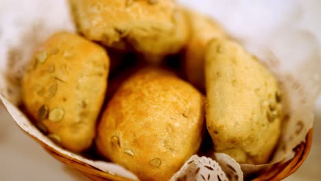 freshly baked rolls, wooden basket, seeds and cloth