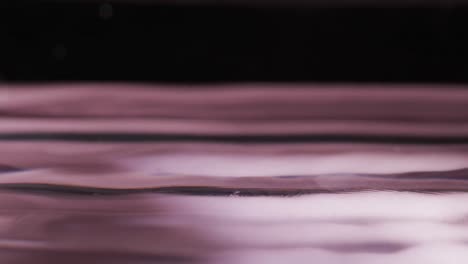 video of close up of drop of water with copy space on pink background