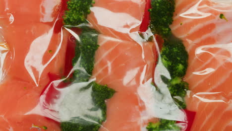 vacuum-sealed salmon skewers with broccoli and red bell peppers