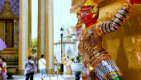 colorful statues and tourists at bangkok temple