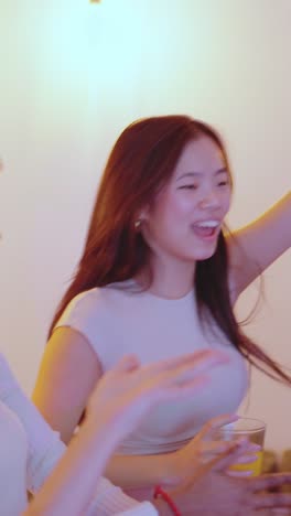 Man dancing while woman circle him on a party