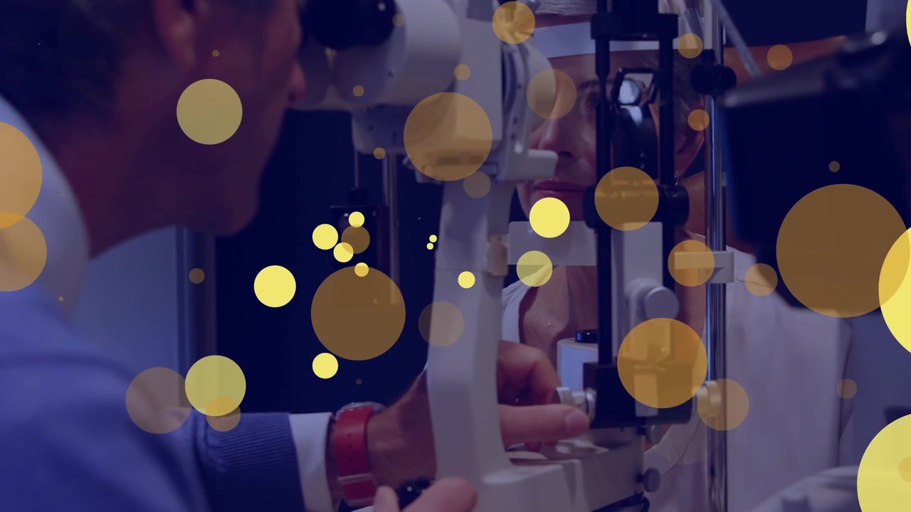 Animation of yellow dots moving over caucasian male eye doctor testing patient