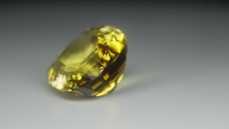 polished yellow gemstone rotates and sparkles