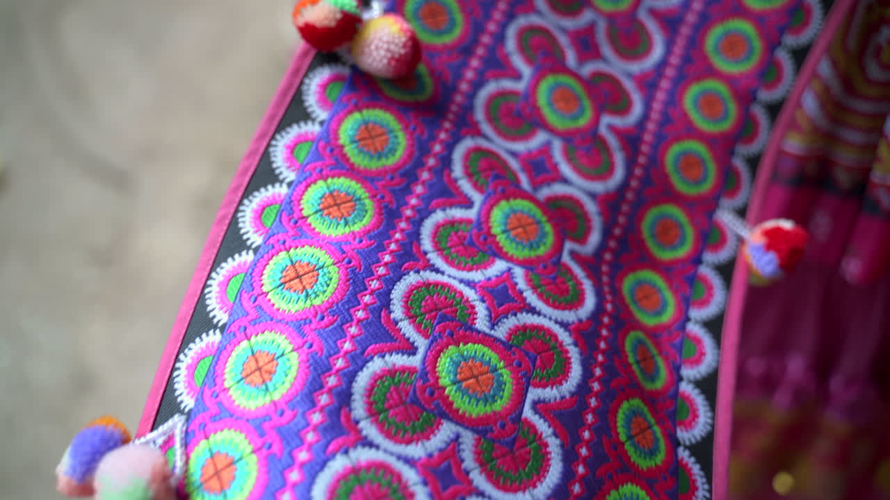 Closeup of bright traditional Thai fabric with detailed ethnic embroidery patterns