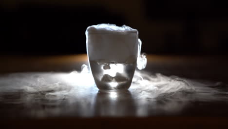 water over dry ice in a glass