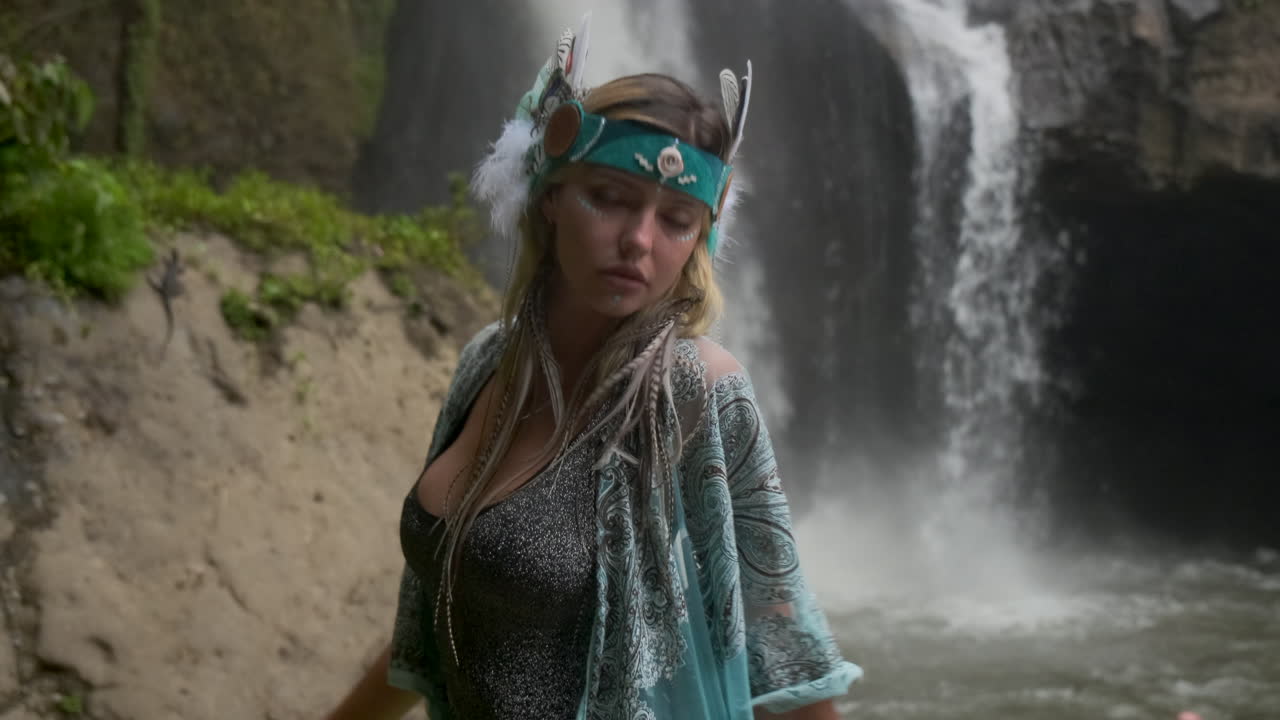 Woman Posing by Waterfall in Nature