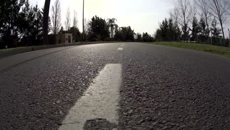 driving a car on a country road / city / neighborhood - pov / plate - point of view front – windshield, low, wide. day.