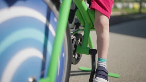 Wheels-of-smoothie-bike-rotating-by-a-young-boy-at-Tour-De-France-in-France