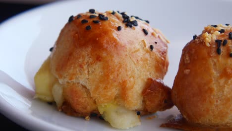 hand picking a pastry on a plate