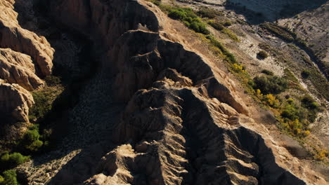 aerial tilt reveal of the zhabyr canyon in national park charyn, in sunny kazakhstan