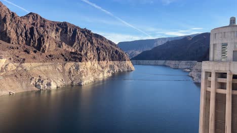 stunning view of hoover dam the colorado river and majestic mountains all in clear lovely weather stunning view of hoover dam the colorado river and majestic mountains all in clear lovely weather