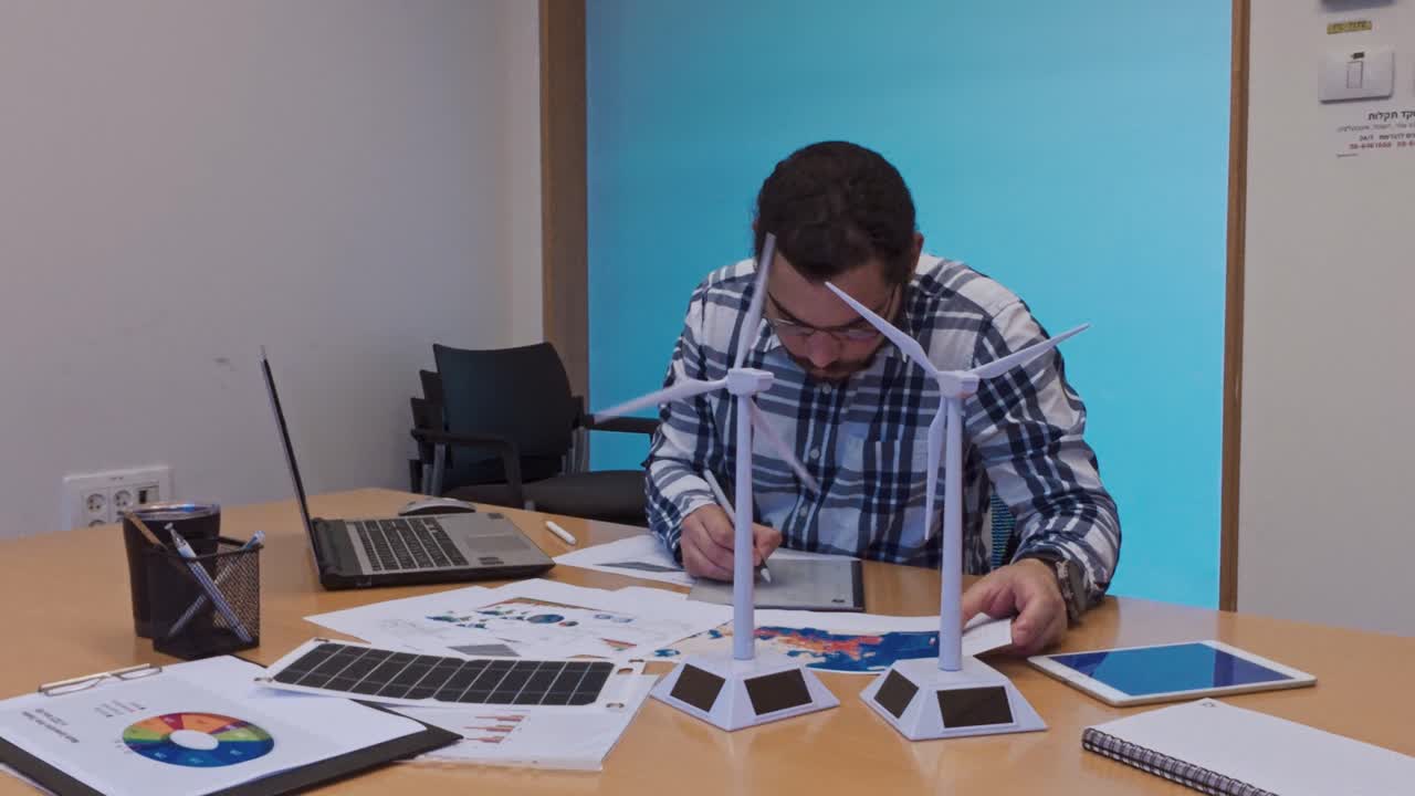 Focused Designer Editing Digital Blueprints on a Graphics Tablet