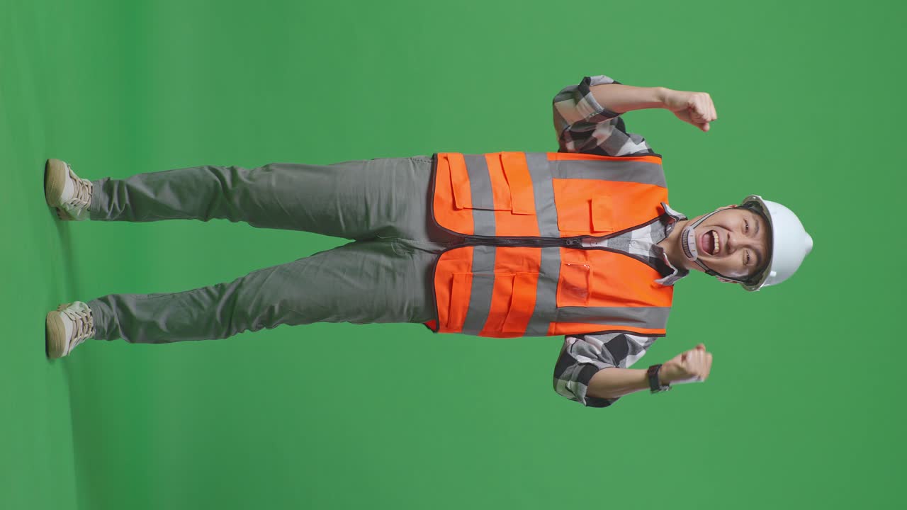 Full Body Of Asian Male Engineer With Safety Helmet Screaming Goal Celebrating Working In The Green Screen Background Studio