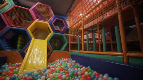 colorful indoor playground with slide and ball pit