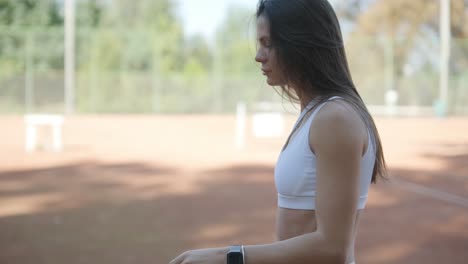 female tennis player practicing serve on outdoor court