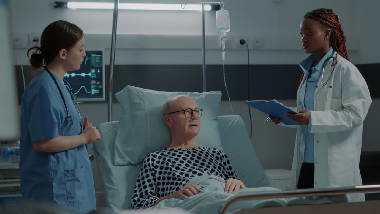 Nurse checking oximeter on sick patient in hospital ward