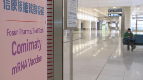 A-banner-promoting-the-Fosun-BioNTech-Pfizer,-Comirnaty-COVID-19-vaccination,-seen-at-a-subway-terminal-station-in-Hong-Kong