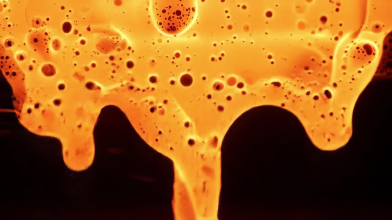 Captivating Flow of Vivid Orange Liquid with Bubbling Bubbles in Dynamic Motion, Showing the Beauty and Intricacy of Fluid Patterns and Textures