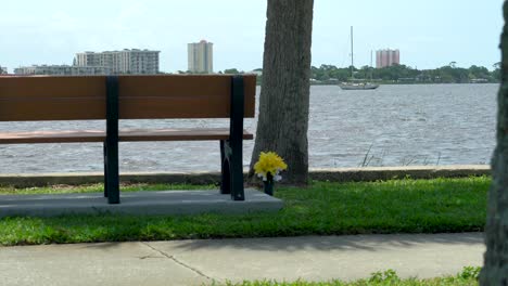 Tranquil-scenic-bench-with-view-of-beautiful-architecture,-river-and-boats