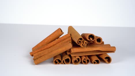 Cinnamon-sticks-against-white-background-dynamic-shot