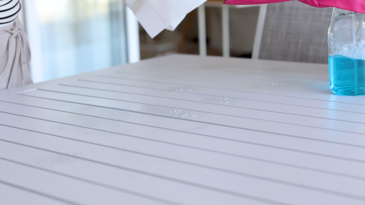 Woman Cleaning Outdoor Table