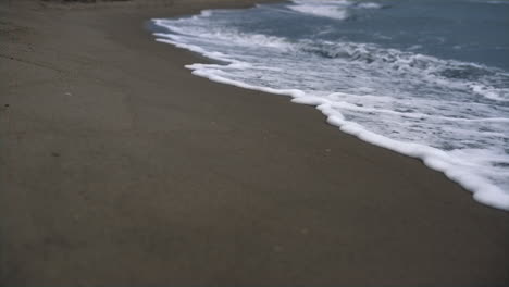 beach waves crashing coastline. sea foam storming blue shore nature background.