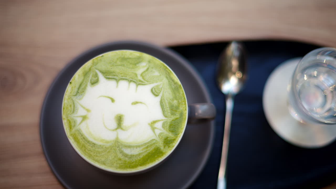 Close up of a latte art cat on a matcha