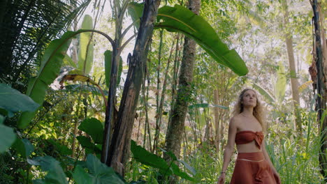 hermosa mujer caminando en el bosque bailando disfrutando de la belleza natural explorando la exuberante jungla tropical sola 4k