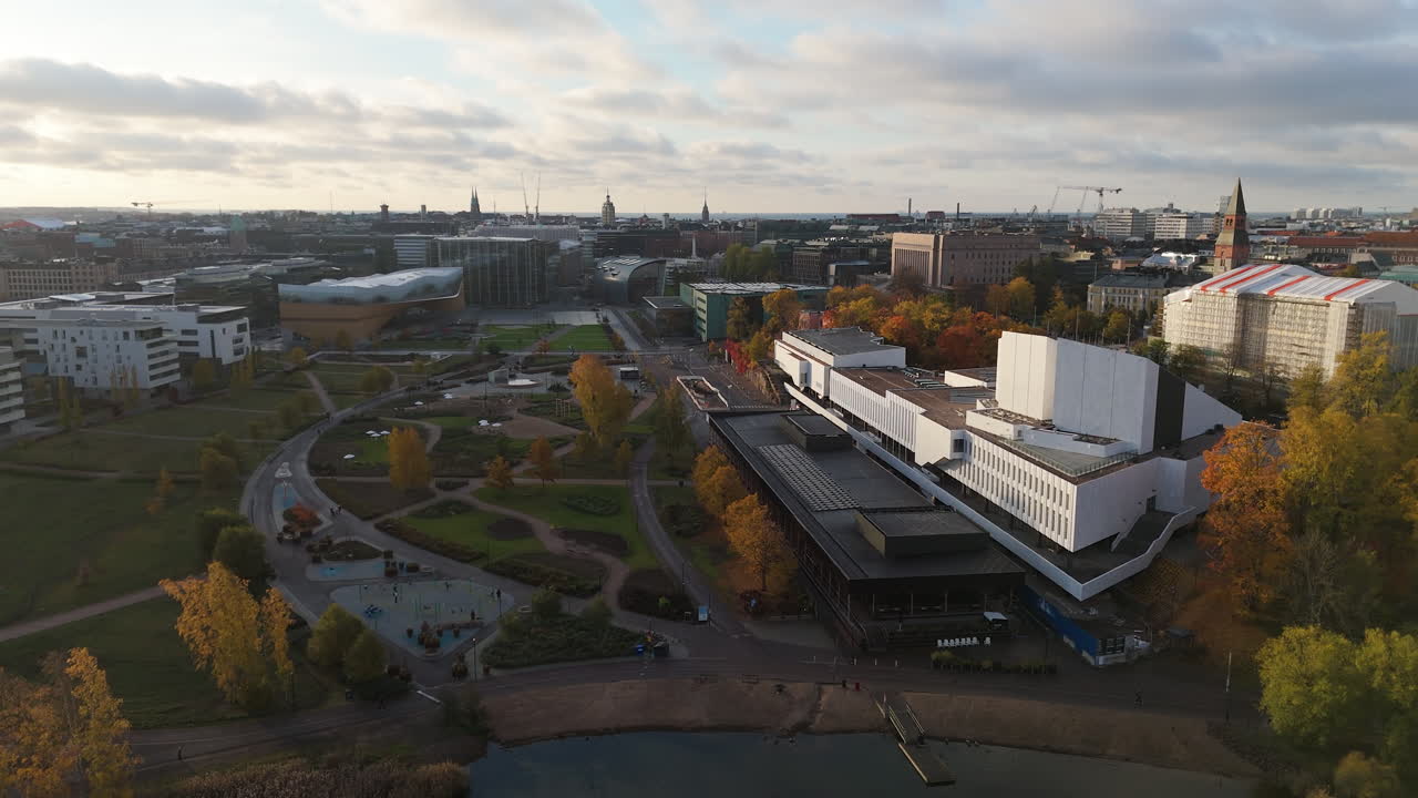 Aerial view of a white building next a park with autumn foliage colors in the centre of Helsinki city in Finland