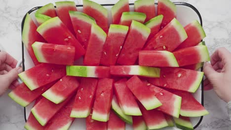 small slices of red seedless watermelon on the tray for the party.