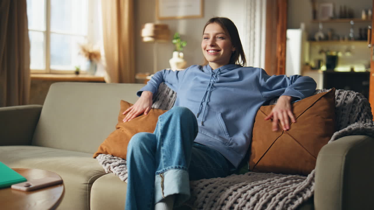 A woman sitting on a couch indoors