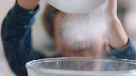 little boy helping mother bake in kitchen mixing ingredients sifting flour using sieve preparing recipe for cupcakes at home