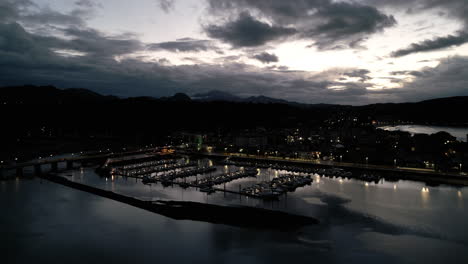 Sunset-Drone-Shot-of-Yacht-Club-in-Ribadesella,-Spain