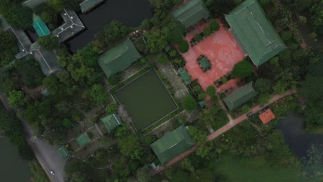 aerial top down clockwise rotation of ancient buddhist temple and gardens in south vietnam