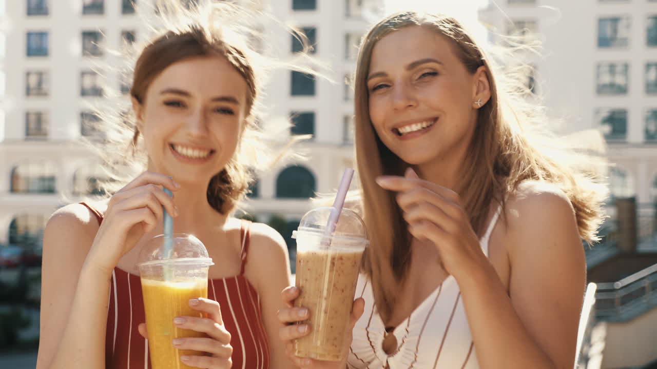 Two Friends Enjoying Drinks Outdoors