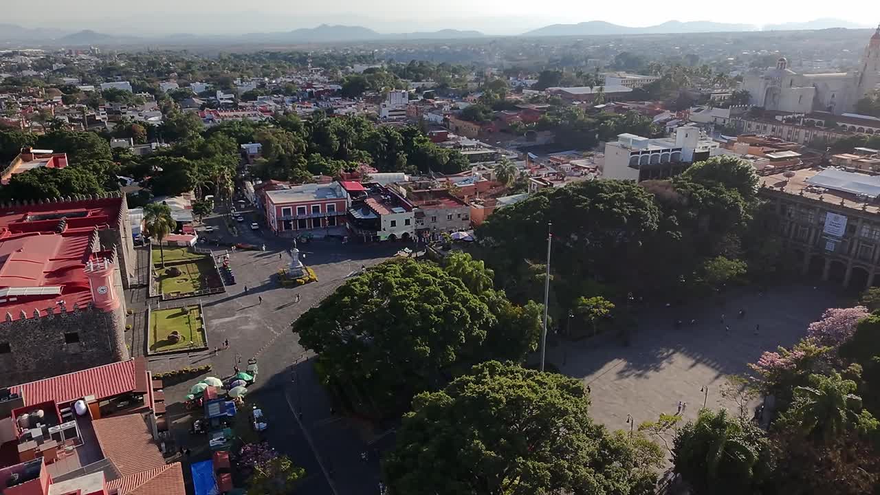 the Palace of Cortés and central plaza surrounded by trees in Cuernavaca. Cuernavaca, Morelos