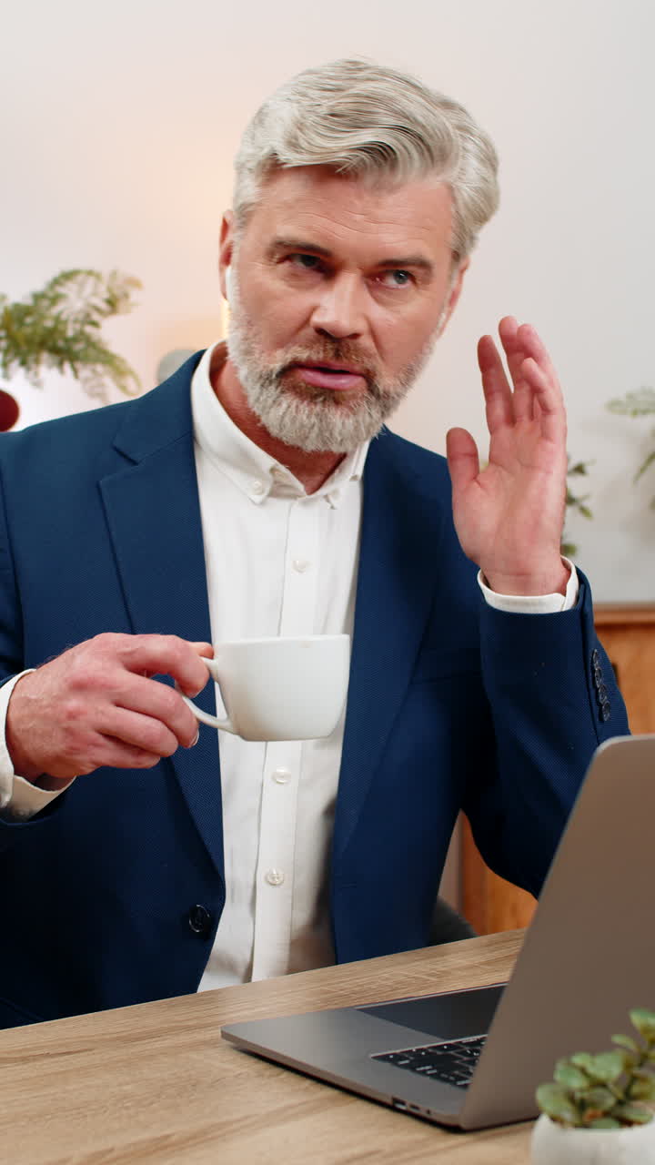 Middleaged businessman with earphones manages call center smiling listening client offering support