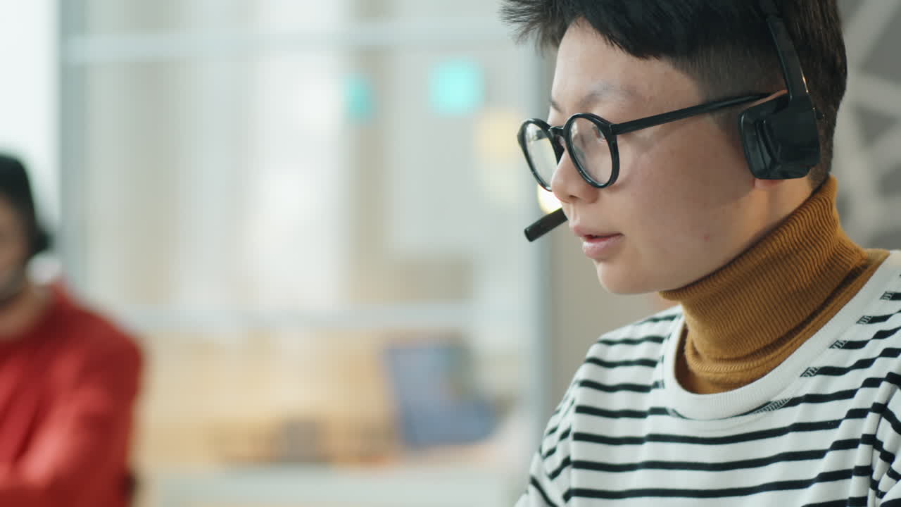 Asian Woman in Headset Working in Call Center