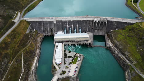 clyde dam building complex in new zealand, aerial drone orbit view