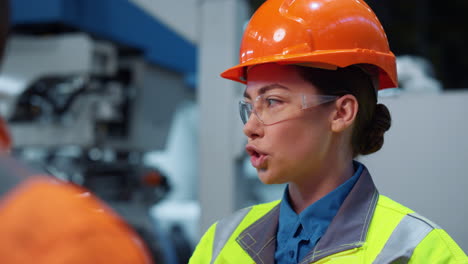 Woman-engineer-talking-unrecognizable-colleague-closeup.-Uniformed-supervisors