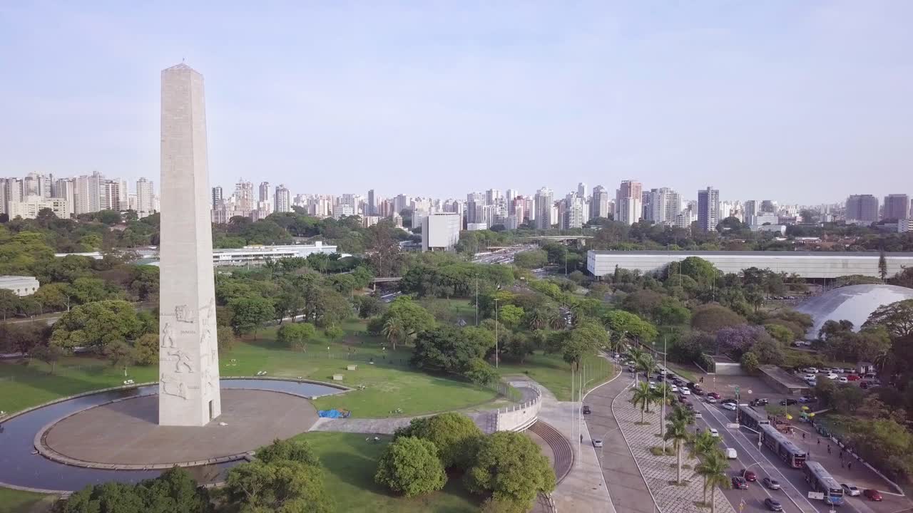 Obelisco monument and buildings in Sao paolo's business center near Avenida Paulista- long aerial slow-moving drone shot